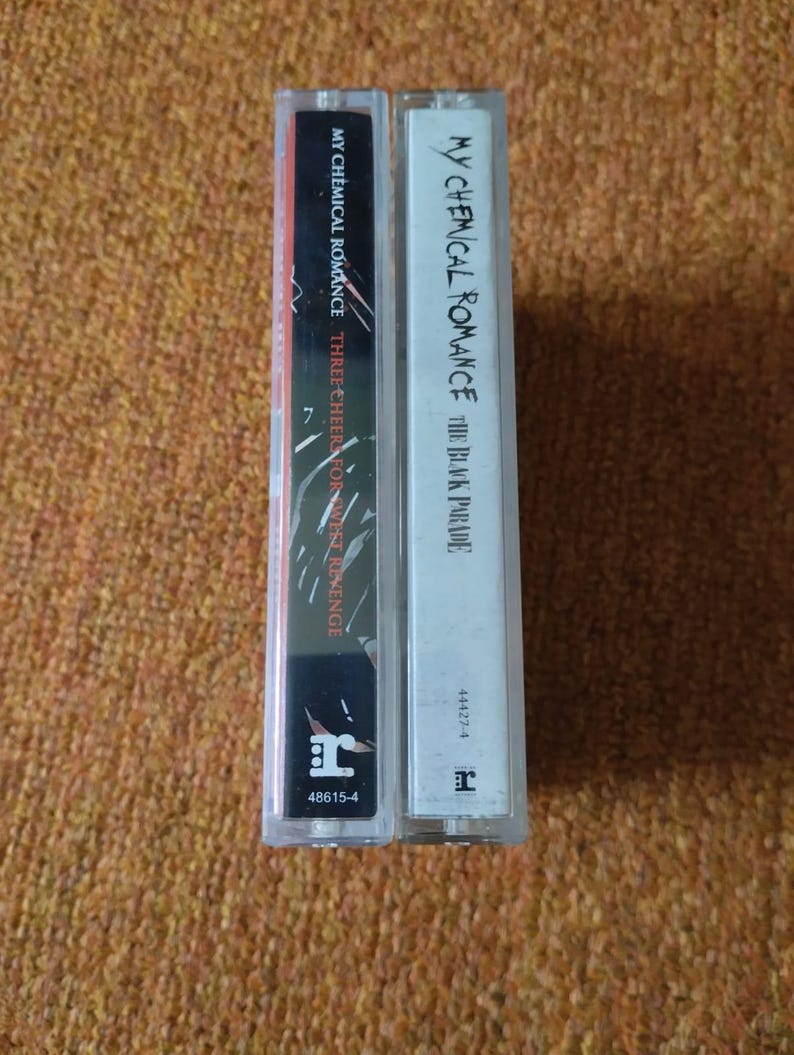 May include: Two cassette tapes, one black and one white, with the band name "My Chemical Romance" and album titles "The Black Parade" and "Three Cheers for Sweet Revenge".