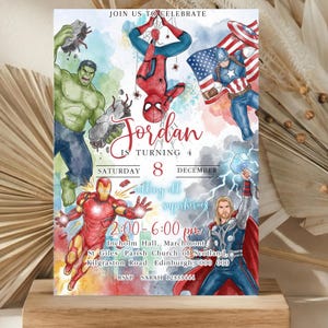 May include: A colorful birthday invitation featuring illustrations of superheroes like Hulk, Spider-Man, Captain America, Iron Man, and Thor. The invitation includes the text "Jordan is turning 4" and event details. The background has watercolor-style splashes.