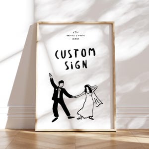 以下が含まれることがあります： ダンスをしているカップルを白黒で描いたイラストで、その上に「CUSTOM SIGN」という文字が書かれています。画像の上部には「ANDREW & AMBER 20.01.18」という文字があります。
