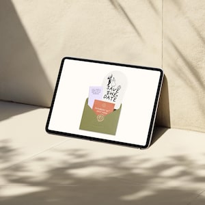 May include: A digital tablet displays wedding stationery, including a 'Save the Date' card with a couple silhouette, and invitation cards in a green envelope. The cards have text and a minimalist design, suggesting a wedding theme.