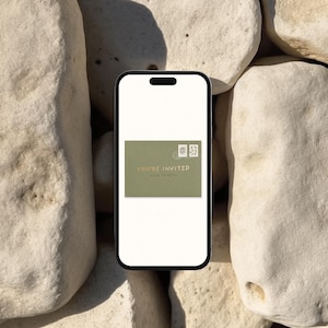 May include: A smartphone displays a digital invitation on a green background. The invitation reads "YOU'RE INVITED" with "CLICK TO OPEN" below. The phone rests on a background of light-colored stones.