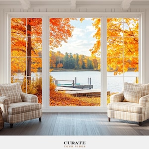 Könnte beinhalten: Zwei beige karierte Sessel vor einem großen Fenster mit Blick auf einen See, einen Holzsteg und Bäume mit orangefarbenem Herbstlaub. Der Text CURATE YOUR VIBES ist in Schwarz und Beige am unteren Rand des Bildes aufgedruckt.