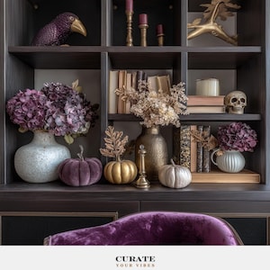 May include: A dark wooden bookshelf display featuring purple hydrangeas in a speckled vase, velvet pumpkins in purple, gold, and white, a gold vase with dried flowers, books, candles, a skull, and a bird figurine. Text reads: CURATE YOUR VIBES.