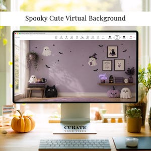 May include: A computer monitor displaying a virtual background featuring a light purple wall decorated with ghost and bat decals, framed art, a shelf with a neon sign reading good vibes, and various ghost and black cat themed decor items.