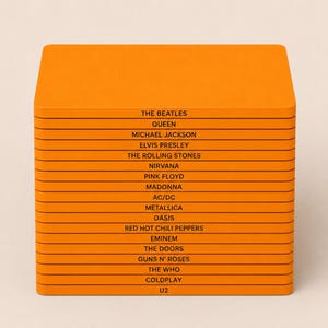 May include: A stack of seventeen rectangular orange coasters, each featuring the name of a famous musical artist or band printed in black text, including The Beatles, Queen, Michael Jackson, Elvis Presley, The Rolling Stones, Nirvana, Pink Floyd, Madonna, AC/DC, Metallica, Oasis, Red Hot Chili Peppers, Eminem, The Doors, Guns N' Roses, The Who, Coldplay, and U2.