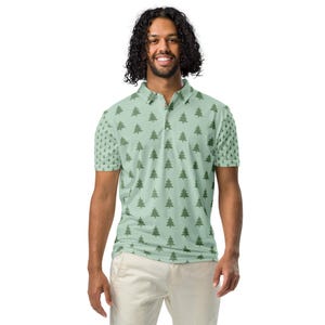 May include: A light green short-sleeved polo shirt with a repeating pattern of dark green stylised pine trees.