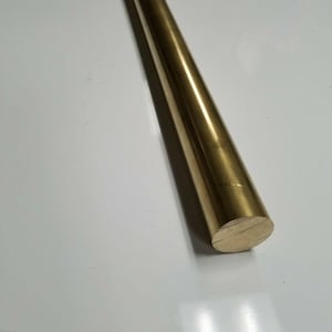 May include: A solid brass rod with a conical shape. The rod is a golden color and has a smooth, polished surface. The rod is approximately 12 inches long.