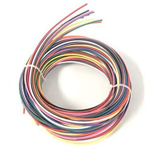 May include: A coiled bundle of multi-colored electrical hook-up wire featuring individual strands in red, blue, green, yellow, white, black, purple, orange, and pink. The circular coil is secured in two places by thin, white plastic zip ties.