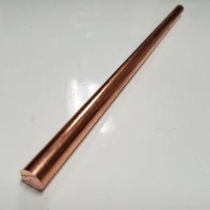 May include: A long, thin, copper rod with a rounded end.