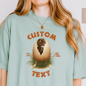 Comfort Colors Dinosaur Park Shirt, Custom Baby Dino Egg Shirt, Universal Family Shirt, Dino Baby Shower Gift, Universal Travel Tee