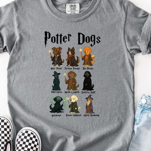 May include: A grey t-shirt with the words "Potter Dogs" and illustrations of dogs dressed as characters from the Harry Potter series. The shirt is paired with blue denim shorts, black and white checkered slip-on shoes, and sunglasses.