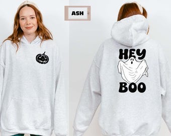 May include: Light gray hoodie with a black jack-o'-lantern graphic on the front and the words "Hey Boo" with a ghost illustration on the back. The hoodie has a hood and a front pocket.
