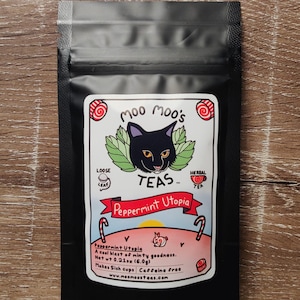 May include: Black tea bag with a label featuring a black cat illustration and the text "Moo Moo's TEAS". The label reads "Peppermint Utopia" and includes details about the tea's flavor and caffeine content. Net wt 0.21 oz (6.0g).