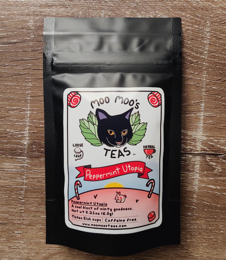 May include: Black tea bag with a label featuring a black cat illustration and the text "Moo Moo's TEAS". The label reads "Peppermint Utopia" and includes details about the tea's flavor and caffeine content. Net wt 0.21 oz (6.0g).