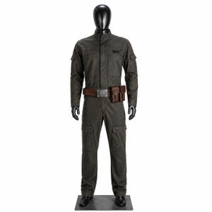 May include: A dark gray long-sleeve jumpsuit featuring a high collar, button-down front, and multiple utility pockets on the chest, arms, and legs. A brown leather belt with a metallic buckle and two attached brown leather pouches is worn at the waist.