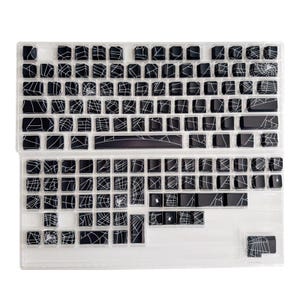 May include: Black and white keyboard keycaps with a spiderweb design. The keycaps are arranged in a standard keyboard layout.