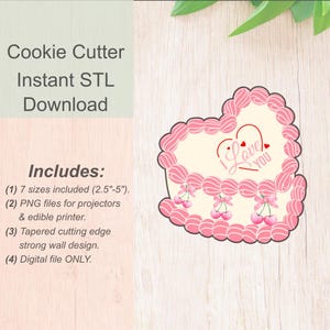 May include: Pink cookie cutter shaped like a heart-shaped cake with the words "I Love You" in the centre. The cutter has a decorative border and cherries around the bottom.