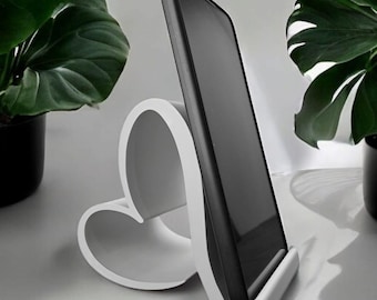 Suporte para celular em formato de coração, ideal para presentear e para maior praticidade com as mãos livres.