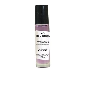 May include: A clear glass roll-on bottle with a black cap, filled with a light purple liquid. The label reads "V.S. BOMBSHELL Women's Fragrance Body Oil O-V453 QUEEN2KEEPUP 1/3 oz."