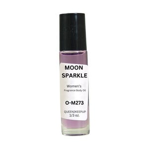 May include: A clear glass roll-on bottle with a black cap, filled with a light purple liquid. The label reads "MOON SPARKLE Women's Fragrance Body Oil O-M273 QUEEN2KEEPUP 1/3 oz."