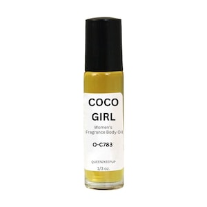 May include: A roll-on fragrance body oil bottle with a black cap and a white label. The label reads "COCO GIRL" and "Women's Fragrance Body Oil". The bottle contains a yellow liquid and is labeled "O-C783" and "1/3 oz."