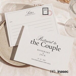May include: A 5 x 7 inch white postcard and matching letter stationery set. The postcard features the text Postcard to the Couple, Rosemary & Jack, 12 07 2027, and Old Marylebone Town Hall. The letter stationery includes a stamp graphic.