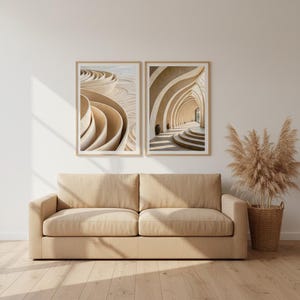 May include: Two framed abstract art prints in beige and tan tones hang above a beige sofa. The prints depict architectural designs with curved lines and arches. A woven basket with dried plants sits to the right of the sofa. The room has a neutral colour palette.