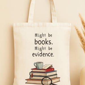 May include: Cream tote bag with the text "Might be books. Might be evidence." A stack of books, a coffee cup, and a magnifying glass are illustrated below the text. The bag has two handles. The bag is made of a light-colored fabric.
