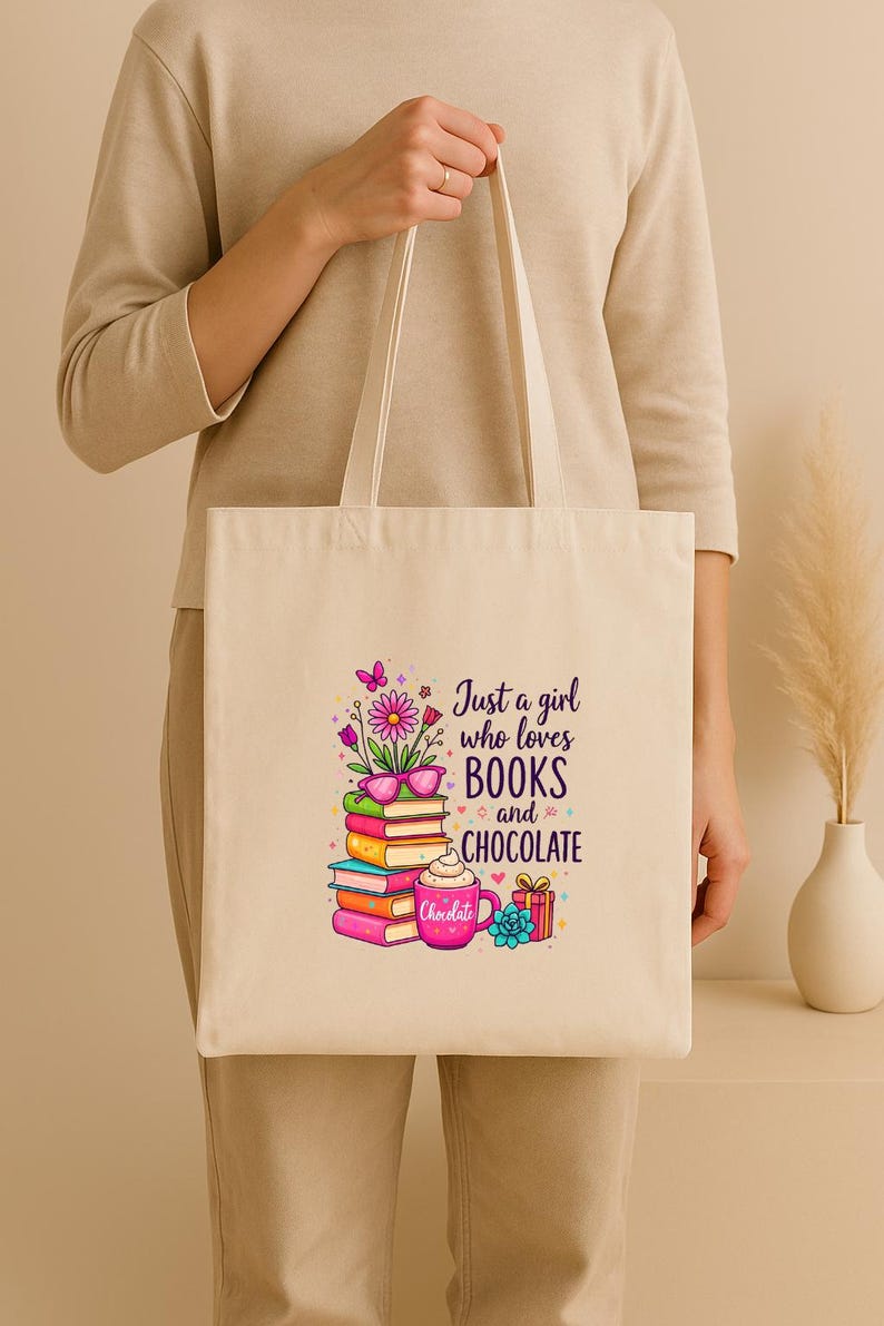 May include: Cream-colored tote bag with the text "Just a girl who loves BOOKS and CHOCOLATE." The graphic includes a stack of books, a coffee mug, and a gift box. The bag is held by a person.