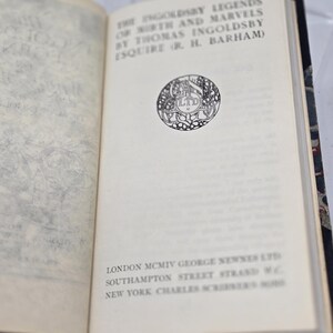 May include: A book titled "The Ingoldsby Legends of Mirth and Marvels by Thomas Ingoldsby Esquire (or R. H. Barham)" with a black and white illustration of a circular logo on the cover. The book was published in 1904 by George Newnes Ltd in London and Charles Scribner's Sons in New York.