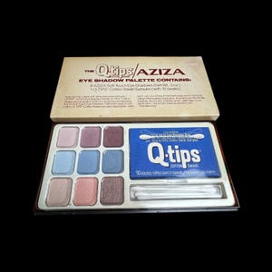 May include: Vintage AZIZA eye shadow palette with nine soft touch eye shadows in various shades of pink, purple, and blue. Includes a Q-tips cotton swab sampler. The palette is in a cardboard box.
