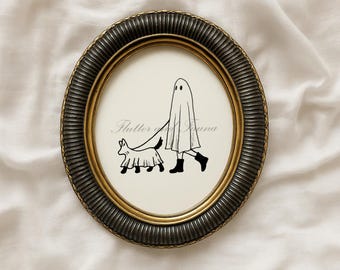 May include: Oval framed art print with a whimsical illustration of a ghost walking a dog, both in ghost costumes. The frame is dark bronze with a gold inner rim. The text "Flutter of Fauna" is printed on the art.