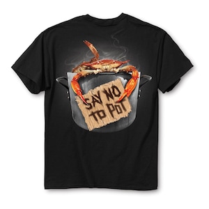 May include: Black t-shirt featuring a crab in a pot with steam rising. The crab is perched atop a pot with a sign that reads "SAY NO TO POT". The crab has orange claws and is set against a dark background.