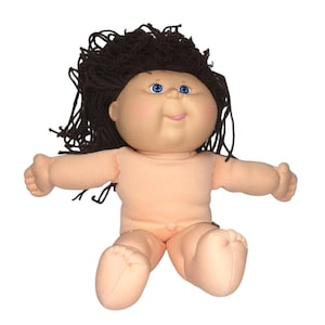 May include: A classic Cabbage Patch Kid doll with a soft, peach-colored body and dark brown yarn hair. The doll has blue eyes, rosy cheeks, and a small, smiling mouth. The doll is in a sitting position with arms outstretched.
