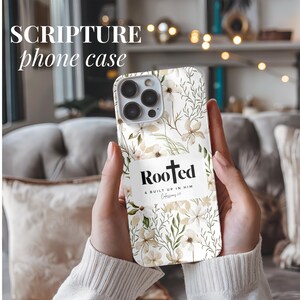May include: A white phone case with a floral pattern and the words "Rooted & Built Up In Him Colossians 2:7" in black text.