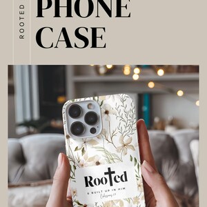 May include: A white phone case with a floral design and the words "Rooted & Built Up In Him Colossians 2:7".