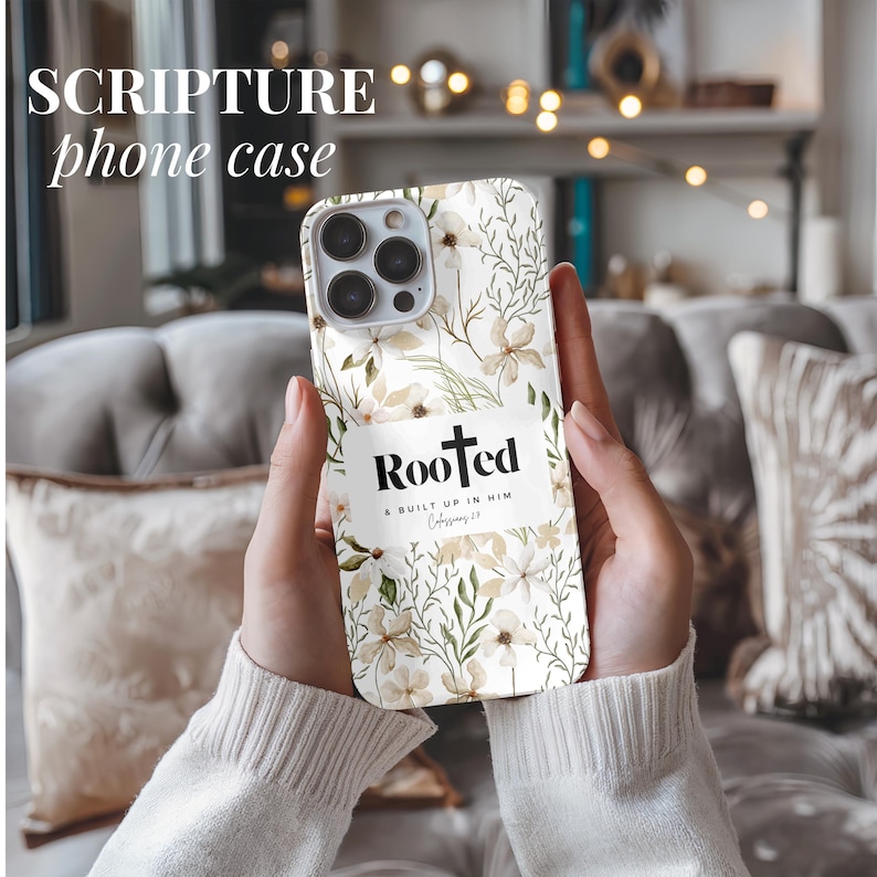 May include: A white phone case with a floral pattern and the words "Rooted & Built Up In Him Colossians 2:7" in black text.