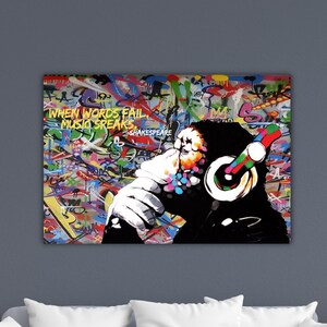 May include: A vibrant canvas print featuring a chimpanzee wearing headphones, set against a graffiti-style background. The artwork includes the text "WHEN WORDS FAIL MUSIC SPEAKS" and is a colorful, modern piece.