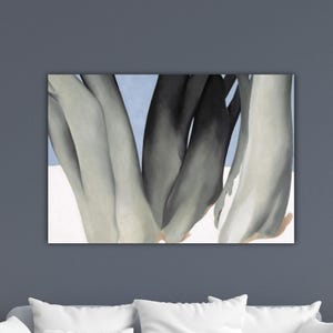 May include: An abstract painting featuring a close-up of several curved, elongated forms in shades of gray and black against a light blue and white background. The artwork is displayed on a rectangular canvas.