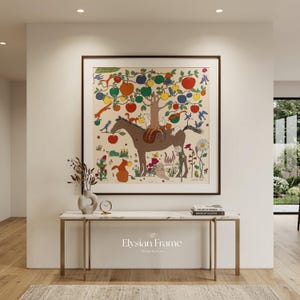 May include: A framed art print featuring a whimsical illustration of a brown horse with a tree growing on its back, laden with colorful fruit. The artwork is set against a cream background and framed in a dark wood. The text "Elysian Frame" is at the bottom.
