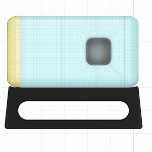 May include: A light blue and yellow rectangular box with a small square window in the center, sitting on a black stand with a cutout in the front.