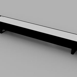 May include: A long, black rectangular shelf with a white top. The shelf is supported by two metal legs on each end.