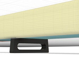 May include: A light blue and cream-colored soundbar with black feet. The soundbar has a rectangular shape and a slightly rounded edge. The soundbar is sitting on a white surface.
