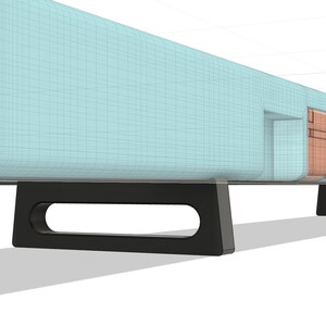 May include: A light blue soundbar with black legs. The soundbar has a series of ports on the back.
