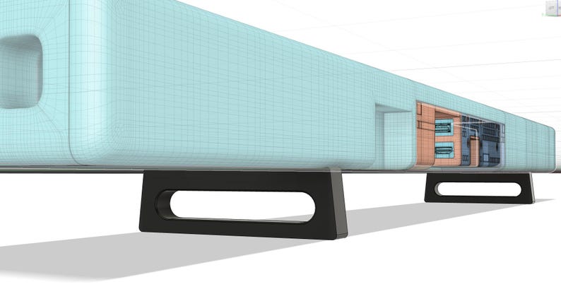 May include: A light blue soundbar with black legs. The soundbar has a series of ports on the back.