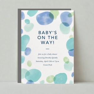 May include: A baby shower invitation with a blue and green watercolour background. The text reads "BABY'S ON THE WAY!" and includes the details of the shower: "Join us for a baby shower honouring Dorothy Quimby Saturday, April 12th at 3 p.m. Grant Park"