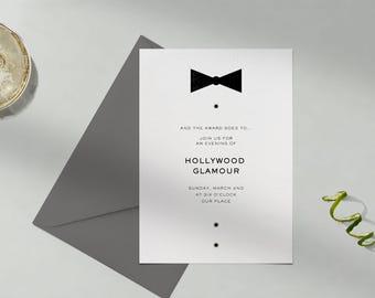 May include: A white invitation card with black text and a black bow tie graphic. The text reads "AND THE AWARD GOES TO... JOIN US FOR AN EVENING OF HOLLYWOOD GLAMOUR SUNDAY, MARCH 2ND AT SIX O'CLOCK OUR PLACE"