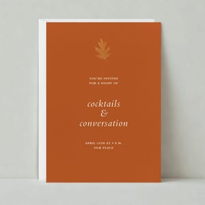 May include: An orange invitation card with a gold leaf design. The text reads "You're invited for a night of cocktails & conversation. April 14th at 9 P.M. Our place."
