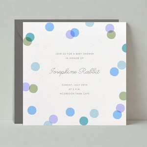 May include: A white baby shower invitation with blue, green, and purple confetti. The invitation reads "Join us for a baby shower in honor of Josephine Rabbit, Sunday, July 28th at 2 p.m., McGregor Farm Cafe."