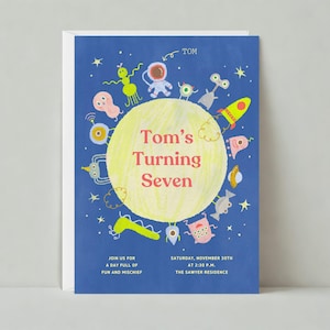 May include: A blue invitation card with a yellow circle in the centre. The circle has the text "Tom's Turning Seven" in red and white. The circle is surrounded by colourful cartoon aliens and stars. The text "Join us for a day full of fun and mischief" and "Saturday, November 30th at 2:30 p.m. The Sawyer Residence" is printed at the bottom of the card.